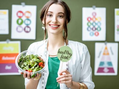 portrait-of-a-woman-dietitian-with-schemes-on-the-topic-of-nutrition.jpg